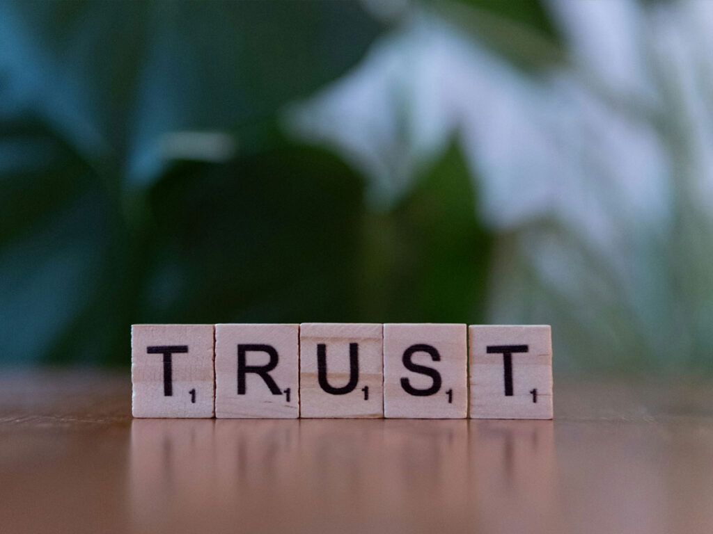 Photo of Scrabble tiles spelling Trust